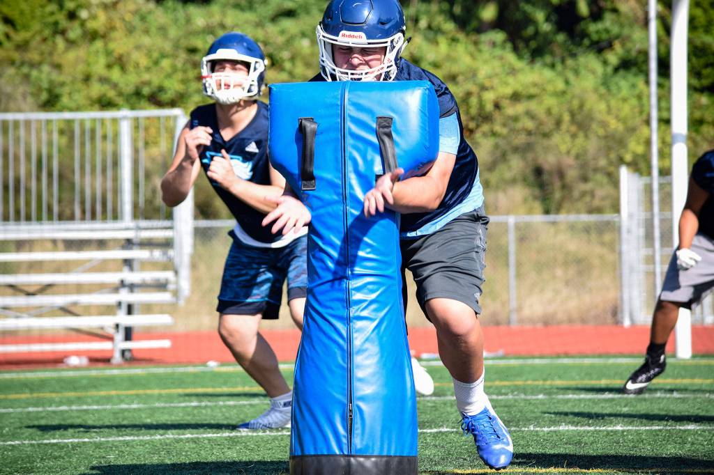 Senior Alex Krueger practices lineman drills at Meadowdale High School on Thursday, Aug. 22. (Katie Webber / The Herald)