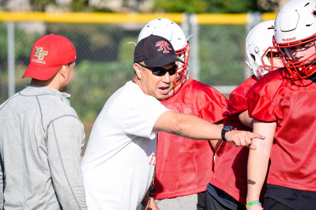 Mountlake Terraces head coach Tony Umayam talks to his players in-between drills at practice on Thursday, Aug. 22. (Katie Webber / The Herald)