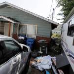 In this July 31 photo, vehicles are parked outside the home of Paige A. Thompson, who uses the online handle erratic, in Seattle. Thompson was arrested last month after the FBI said she obtained personal information from more than 100 million Capital One credit applications. (AP Photo/Ted S. Warren, File)