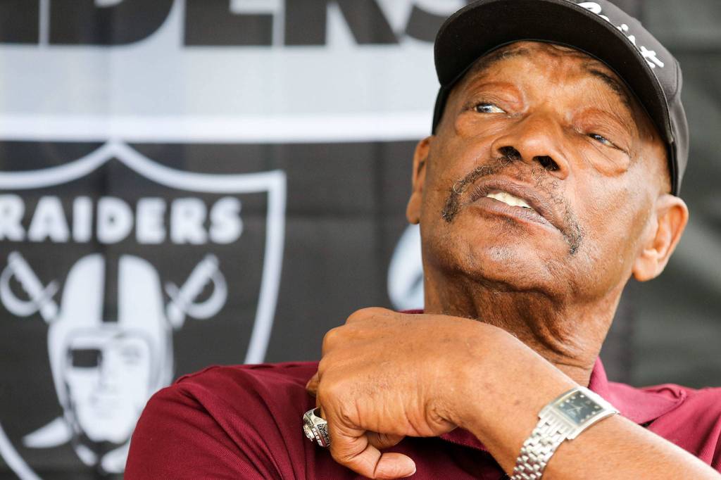 Otis Sistrunk, former NFL defensive lineman, talks with visitors to his tent during the Bill Baker Memorial Steel and Wheel Car Show at Everett Machinists Hall on Aug. 17. (Kevin Clark / The Herald)