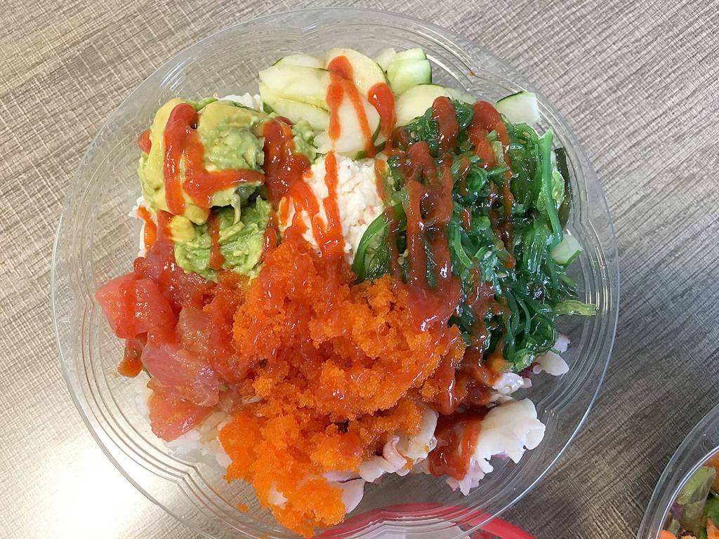 The build-your-own poke bowl options are extensive at Umami. Bowls start with a base of either rice or mixed greens salad, or half of each. Then you pick one of 12 proteins, from albacore tuna to octopus to tofu, and toppings such as carrot, edamame, snow crab and seaweed salad. (Ben Watanabe / The Herald)