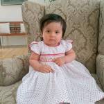 Chiara Harkness, 1, has brown eyes and black hair, is 2 feet tall, weighs 20-25 pounds and has a birth defect on unknown toe that is bent under the foot. She was last seen wearing a blue flower dress. (Photo courtesy of the Washington State Patrol)