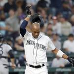Seattles Keon Broxton (foreground) knocks his helmet off after striking out looking, as Yankees catcher Austin Romine heads to the dugout in the second inning the Mariners 5-4 loss on Monday in Seattle. Broxton was ejected for arguing the called third strike. (AP Photo/Elaine Thompson)