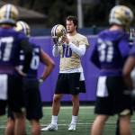 Jacob Eason takes his helmet off between drills during football practice at the University of Washington on April 3 in Seattle. (Olivia Vanni / Herald file)