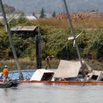 Contractors for the state Department of Ecology investigate a sunken sailboat Aug. 20 on the Snohomish River. (Joey Thompson /Herald file)