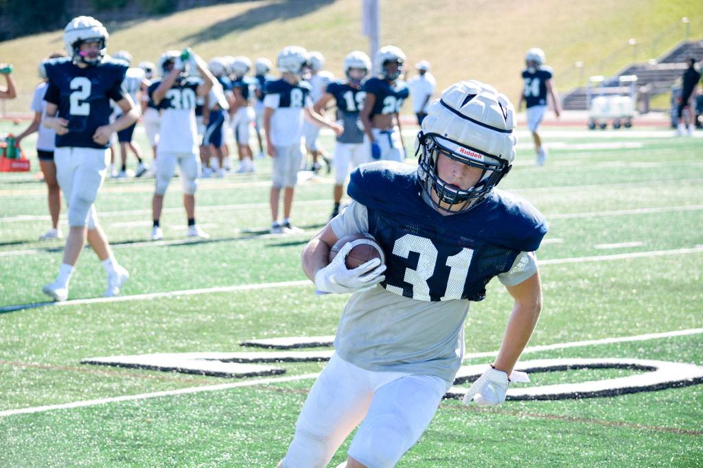 Junior Patrick McKenzie runs to the endzone during football practice on Aug. 27, 2019, at Glacier Peak High School in Snohomish. (Katie Webber / The Herald)