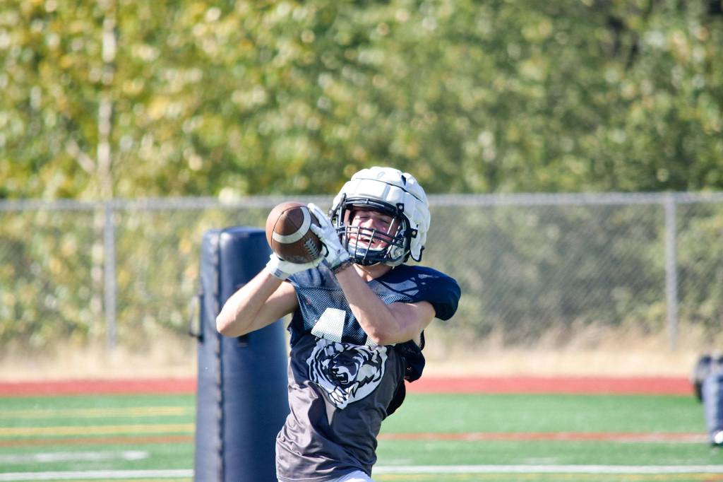 Junior Trevor Meldrom catches the ball while practicing offensive plays during football practice on Aug. 27, 2019, at Glacier Peak High School in Snohomish. (Katie Webber / The Herald)