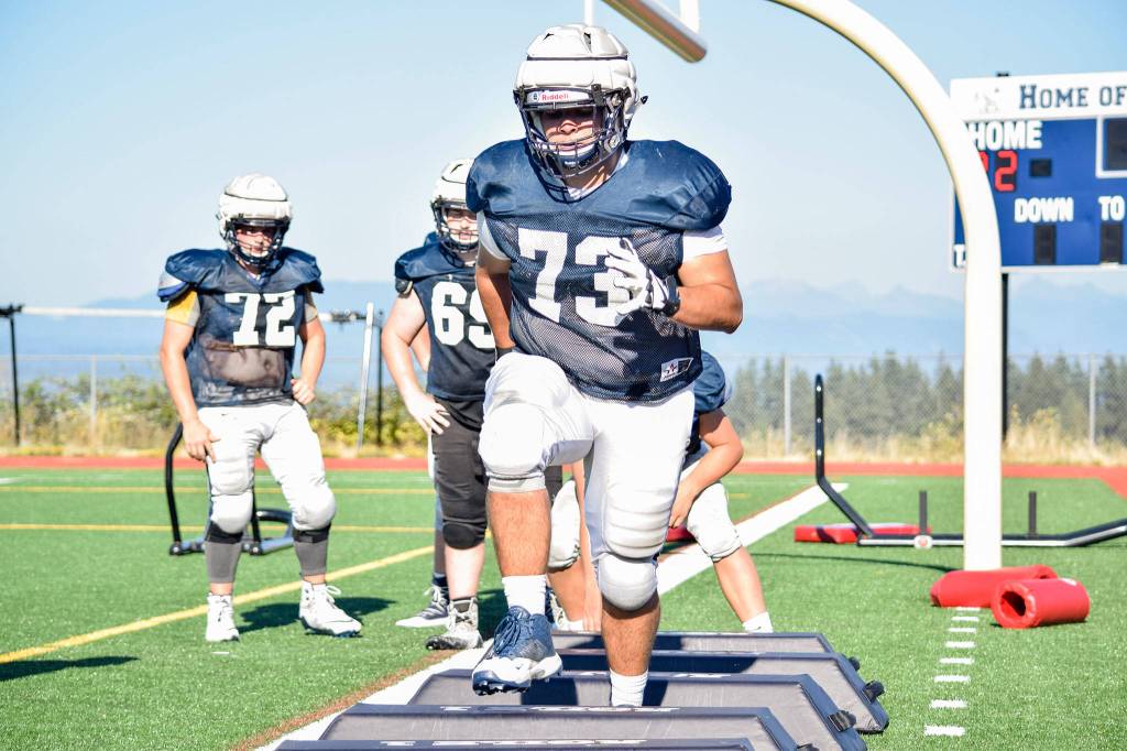 Senior Mason Bridges practices quick feet with the linemen during football practice on Aug. 27, 2019, at Glacier Peak High School in Snohomish. (Katie Webber / The Herald)
