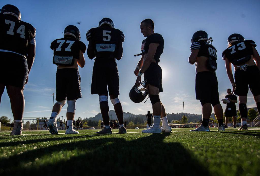 Monroe players wait to be called into a drill during practice. (Olivia Vanni / The Herald)