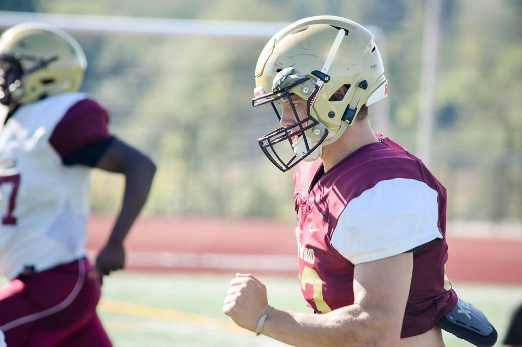 Senior Brandt Starkey sprints to the sidelines during conditioning drills on Aug. 28, 2019, at Lakewood High School in Arlington. (Katie Webber / The Herald)