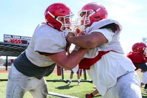 Justin Albee (left) crashes with Lukas Ramos during practice Wednesday afternoon at Quil Ceda Stadium in Marysville on August 28, 2019. (Kevin Clark / The Herald)