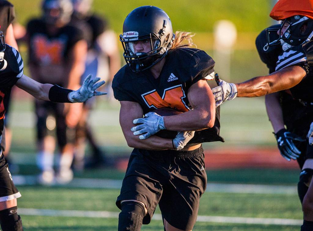 Garrett Fuller runs the ball during football practice at Monroe High School on Wednesday, Aug. 28, 2019 in Monroe, Wash. (Olivia Vanni / The Herald)