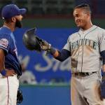 The Mariners Mallex Smith (right) jokes with Rangers shortstop Danny Santana after stealing second base during the fifth inning of a game on Aug. 29, 2019, in Arlington, Texas. (AP Photo/Louis DeLuca)