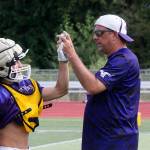 Lake Stevens head coach Tom Tri congratulates a player during a recent practice. (Andy Bronson / The Herald)