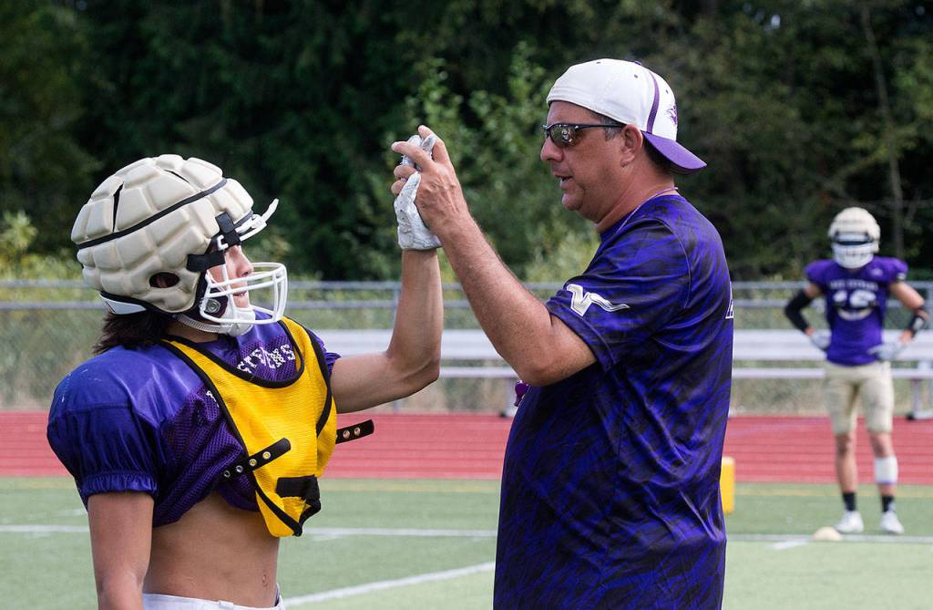 Lake Stevens head coach Tom Tri congratulates a player during a recent practice. (Andy Bronson / The Herald)