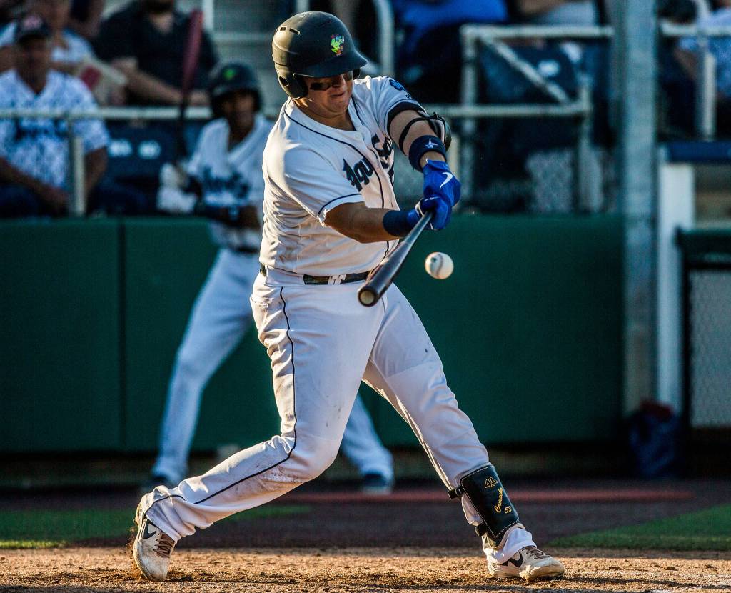 AquaSoxs Juan Camacho hits a home run in the 7th inning against the Eugene Emeralds at Funko Field on Aug. 25 in Everett. (Olivia Vanni / The Herald)