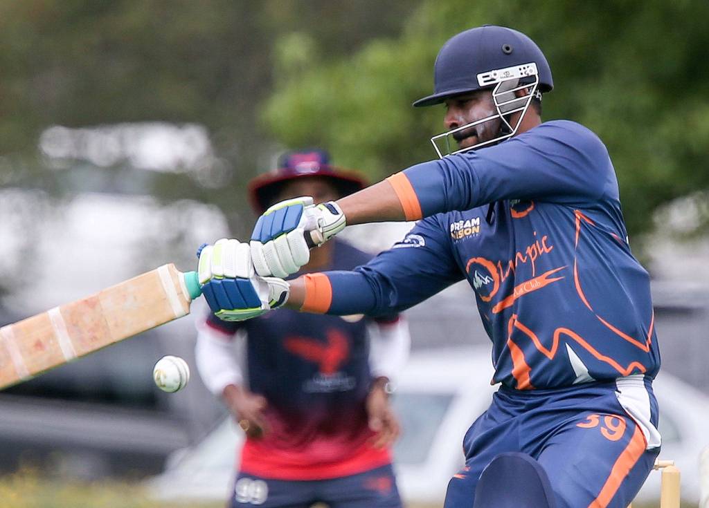 Sri Kattas swings at the ball during a cricket game at McCollum Park in Mill Creek on Aug. 18. (Kevin Clark / The Herald)