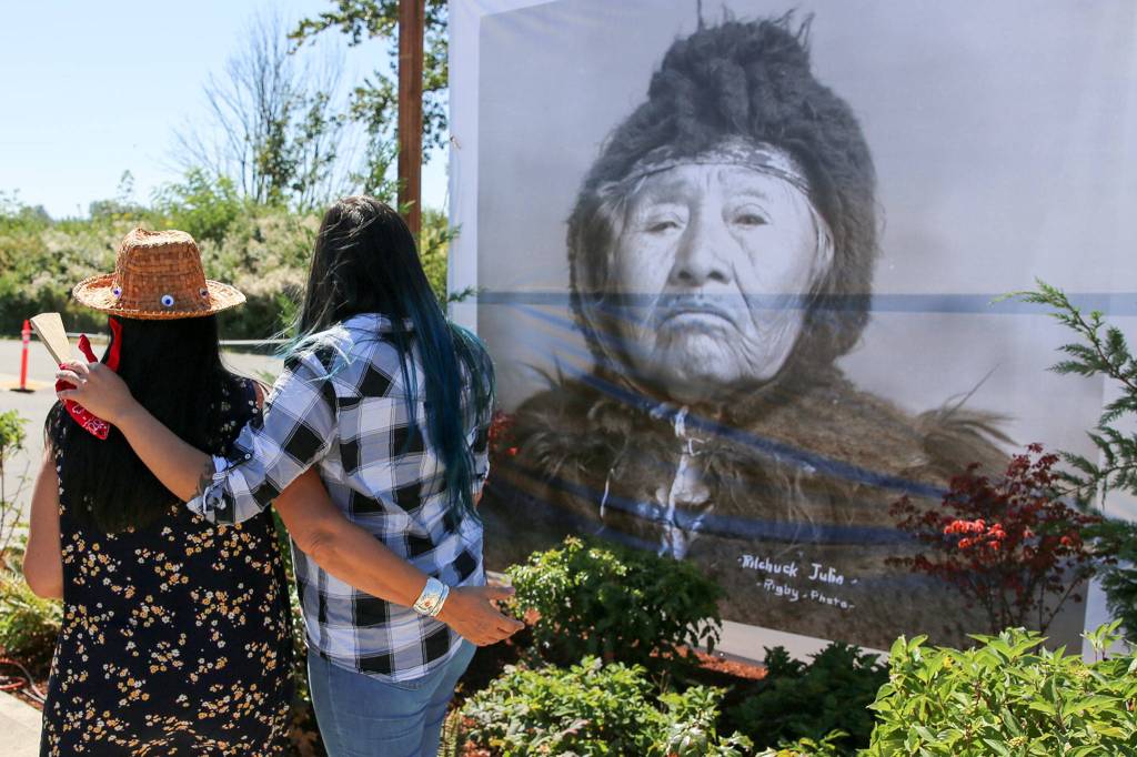 Guests gather to view a photo of Pilchuck Julia during the naming ceremony of the landing named for her in Snohomish on Aug. 27. (Kevin Clark / The Herald)