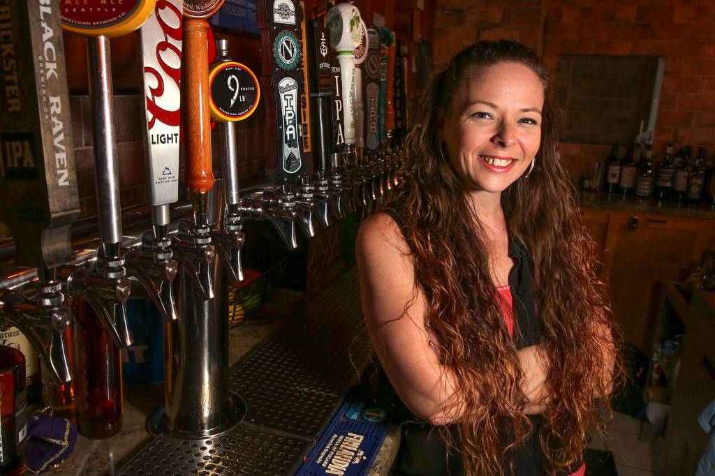 Megan Bingaman tends bar at the Village Taphouse Grill in Marysville. (Kevin Clark / The Herald)
