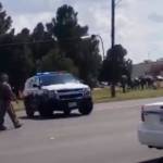 In this image made from video, police officers guard on a street in Odessa, Texas, on Saturday. (Dustin Fawcett via AP)