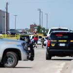 Odessa and Midland police and sheriffs deputies surround the area behind Cinergy in Odessa, Texas, on Saturday, after reports of shootings. (Tim Fischer/Midland Daily News via AP)