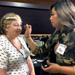Erika Jones, makeup artist at The Refinery Salon In Edmonds, gives Julie Wiese a makeover during the first YWCA Seattle King Snohomish RISE Career Training Workshop for women Aug. 22 in Edmonds. (Janice Podsada / The Herald)