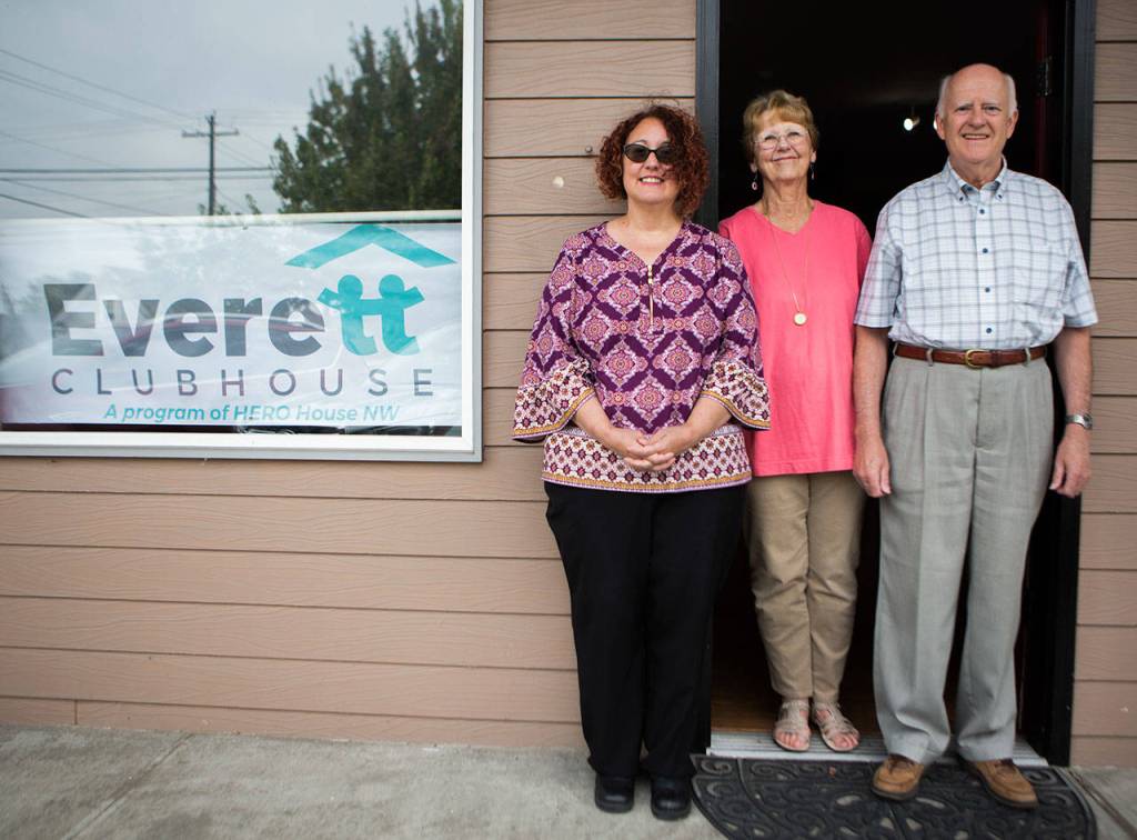 Program director Soozee McNamara (left) and Meg and Harold McClure stand outside the new Everett Clubhouse. (Olivia Vanni / The Herald)