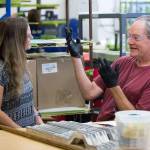 Using signs and a bit of lip-reading, masker Brian Jensen communicates with masking supervisor Patsy Caban at Valence Surface Technologies in Everett. (Andy Bronson / The Herald)