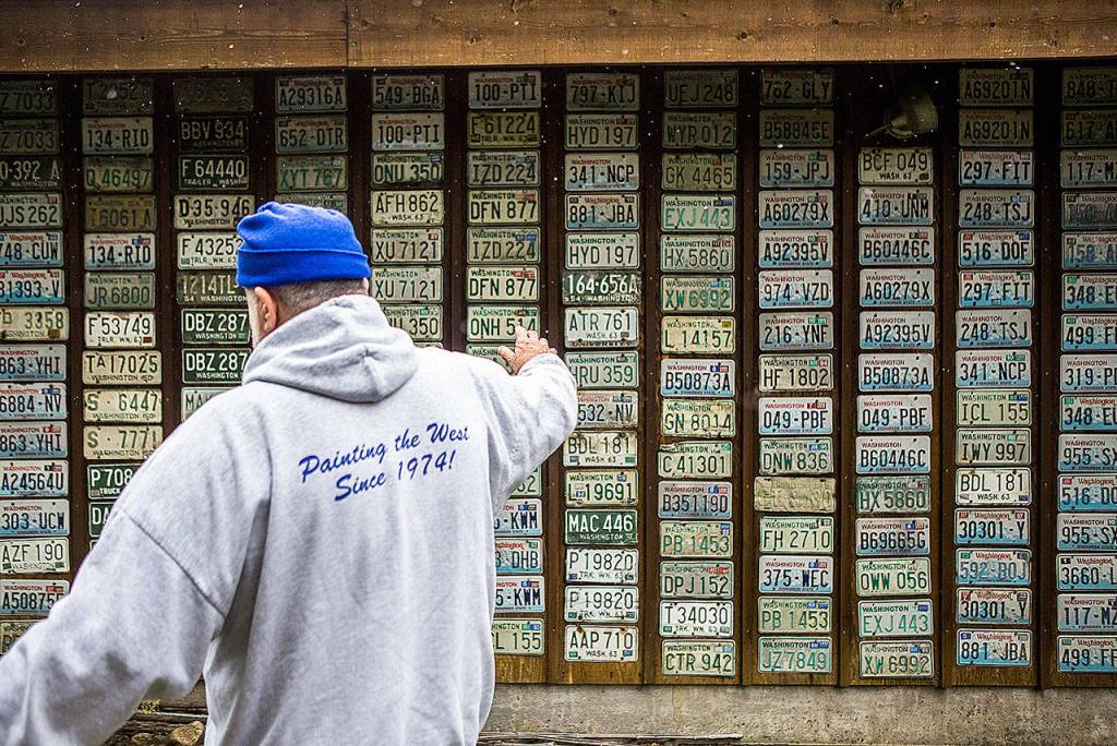 Ron Nardone talks about his collection of license plates, just a small bit of the stuff he has amassed since he starting collecting signs in the 1950s. (Olivia Vanni / The Herald)