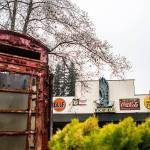 A phone booth sits in the foreground while large signs cover the front of one of the many buildings at NardoLand. (Olivia Vanni / The Herald)