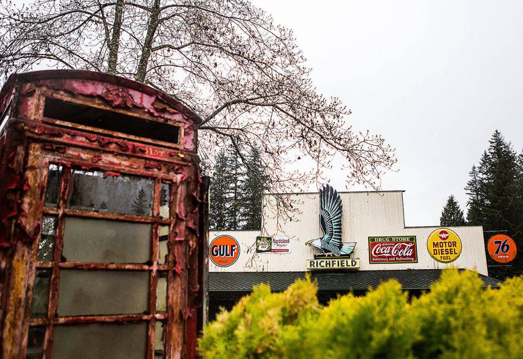 A phone booth sits in the foreground while large signs cover the front of one of the many buildings at NardoLand. (Olivia Vanni / The Herald)