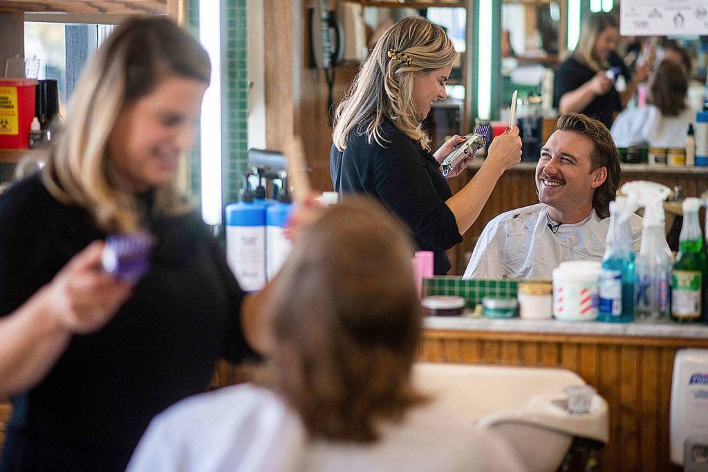 Country singer Morgan Wallen receives a mullet at Paul Mole Barber Shop in New York. Wallen, who has turned heads with his likable hit song Whiskey Glasses, said he decided to try a mullet after seeing old photos of his dad proudly rocking the hairstyle. (Photo by Charles Sykes/Invision)