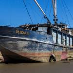 Awaiting a barge and crane, Midas’ removal floats downstream