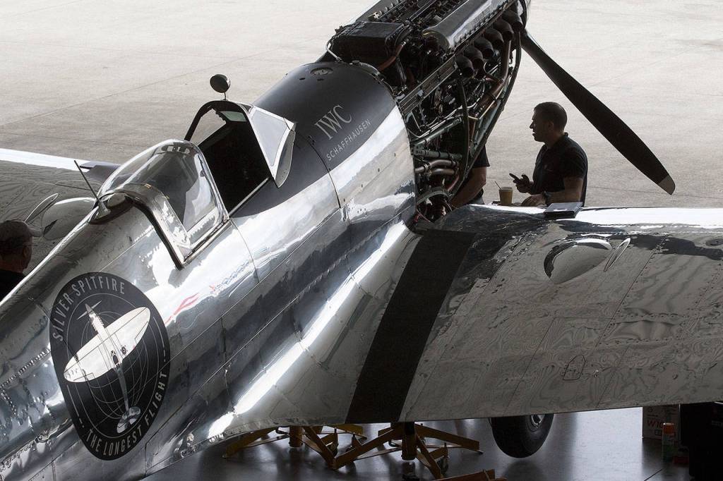 Chief Engineer Gerry Jones talks to a fellow mechanic in front of the Silver Spitfire. (Andy Bronson / The Herald)