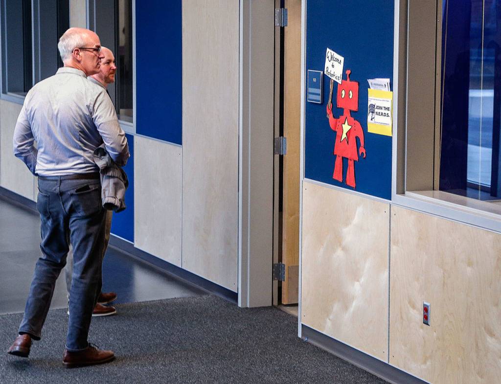 While touring Everetts North Middle School on the first day of classes Wednesday, Congressman Rick Larsen (left) and Principal Mitch Entler do an about-face to watch a robotics class through through the open door. (Dan Bates / The Herald)