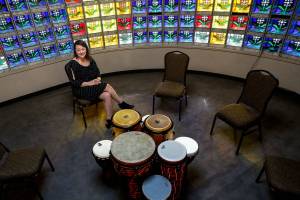 Vasheti Quiros, executive director of the Snohomish County Music Project, is more than pleased with the former Purdy & Walters with Cassidy Funeral Home facilities. The site on Everetts Pacific Avenue is the nonprofits new home. Here, she shows a small room, circled by stained glass, used for drum circles and meditative activities. (Dan Bates / The Herald)
