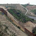 In this March 11 photo, construction crews replace a section of the primary wall separating San Diego (above right) and Tijuana, Mexico (below left), seen from Tijuana, Mexico. (AP Photo/Gregory Bull, File)