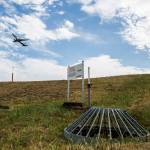 An airplane takes off from the runway over the top of one of the water drainage shut-off valves installed around Paine Field to help prevent water runoff contamination on Sept. 5 in Everett. (Olivia Vanni / The Herald)