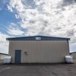 Two large containers sits next to a airplane hangar at to help filter rain water runoff from the roofs at Paine Field on Sept. 5 in Everett. (Olivia Vanni / The Herald)
