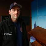 Aaron Boede, 30, near the Arlington Fire Departments 9/11 memorial display at 137 N. Macleod Ave. (Dan Bates / The Herald)