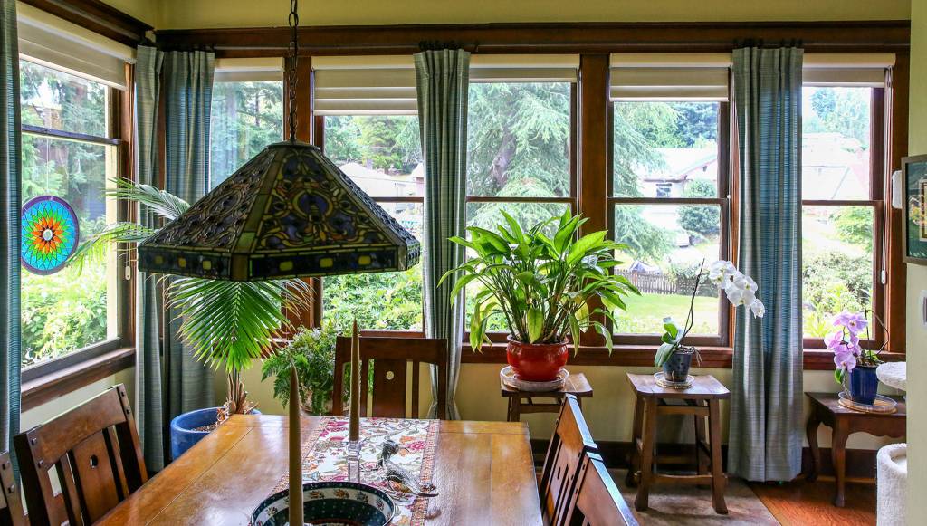 Light pours into the main living area of the 110-year-old Mausshardt home, thanks to banks of windows on multiple sides of the room. (Kevin Clark / The Herald)