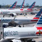 In this April 24 photo, American Airlines aircraft are shown parked at their gates at Miami International Airport in Miami. (AP Photo/Wilfredo Lee, File)