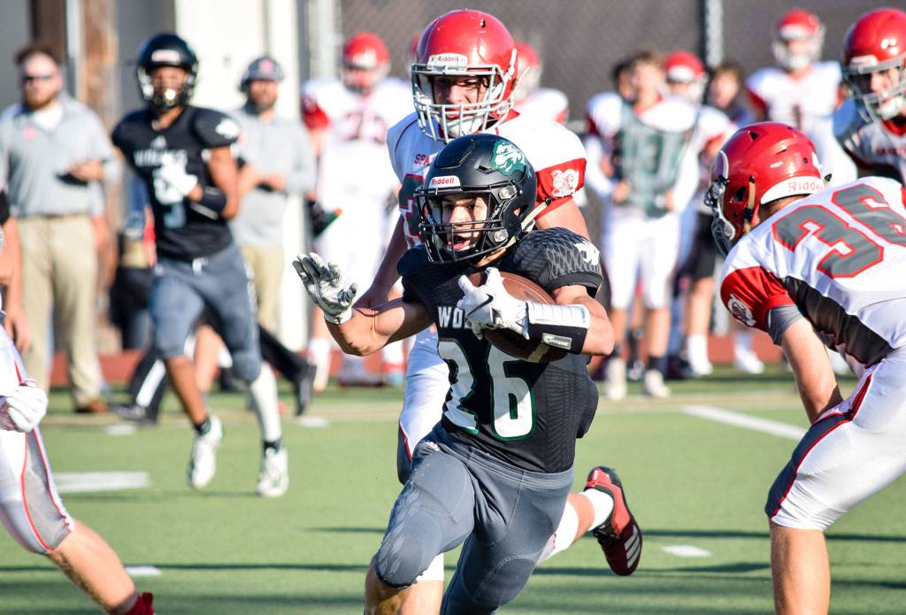 Junior running back Brendan Sandico runs against Stanwood on Friday at Everett Memorial Stadium. (Katie Webber / The Herald)
