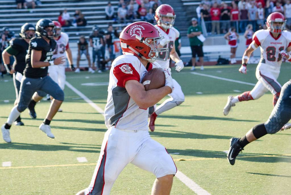 Freshman wide receiver Ryder Bumgarner runs for a first down against Jackson on Friday at Everett Memorial Stadium. (Katie Webber / The Herald)