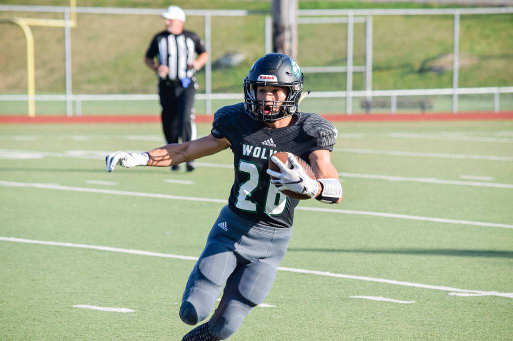 Junior running back Brendan Sandico runs for a first down against Stanwood on Friday at Everett Memorial Stadium. (Katie Webber / The Herald)
