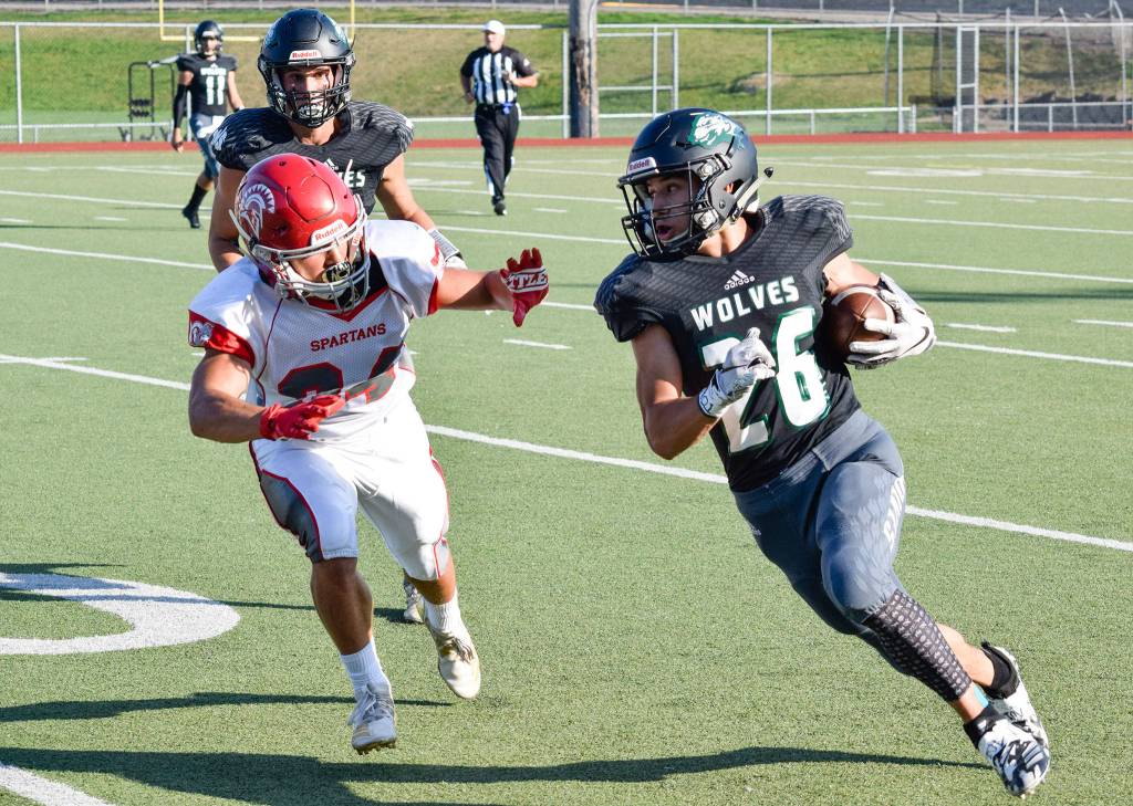 Junior running back Brendan Sandico runs for a first down against Stanwood on Friday at Everett Memorial Stadium. (Katie Webber / The Herald)