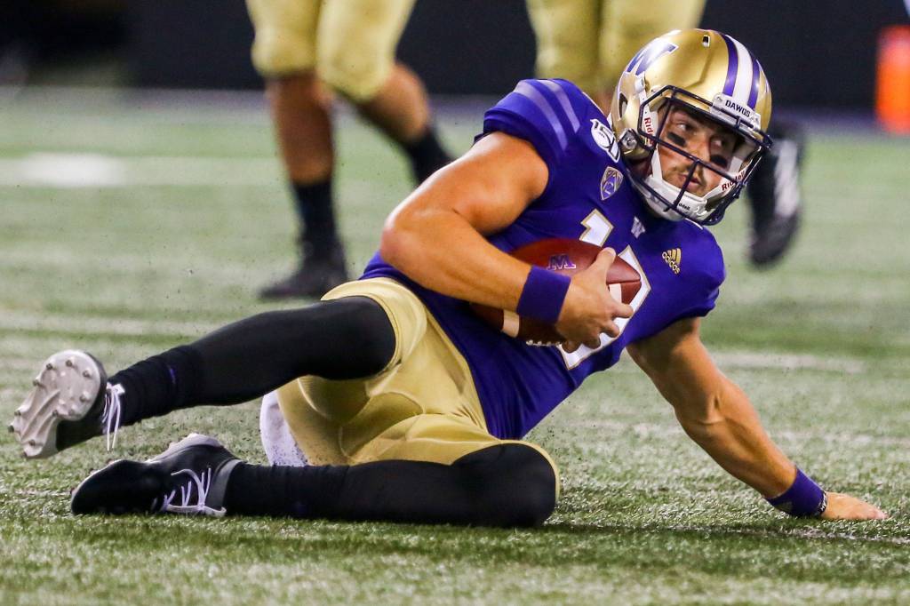 Washingtons Jacob Eason slides shy of a first down in the first quarter Saturday night at Husky Stadium in Seattle on September 7, 2019.(Kevin Clark / The Herald)