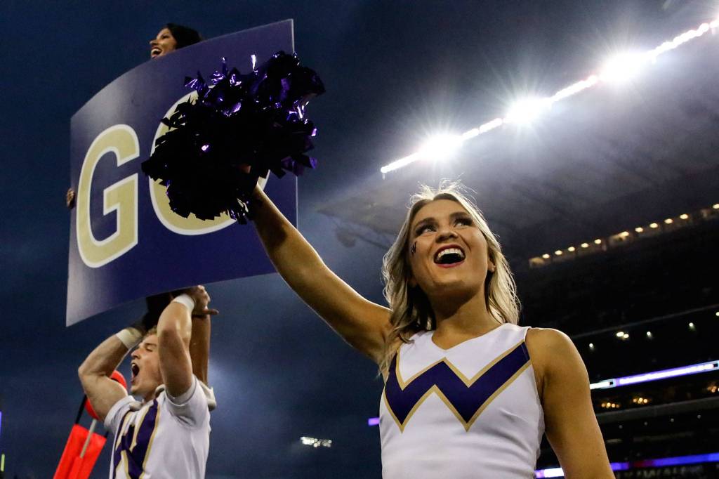 Members of the cheer rally the crowd Saturday night at Husky Stadium in Seattle on September 7, 2019.(Kevin Clark / The Herald)