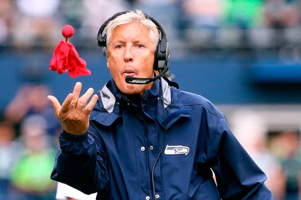 Seahawks head coach Pete Carroll throws the challenge flag at CenturyLink Field during Sundays game against the Cincinnati Bengals. (Kevin Clark / The Herald)