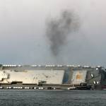 Smoke rises from a cargo ship that capsized in St. Simons Island Sound in Georgia on Sunday. (Bobby Haven / The Brunswick News)